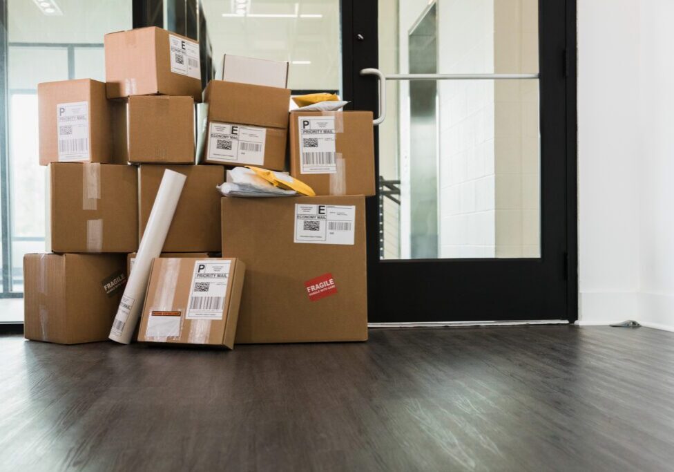Stacked cardboard boxes near glass doors.